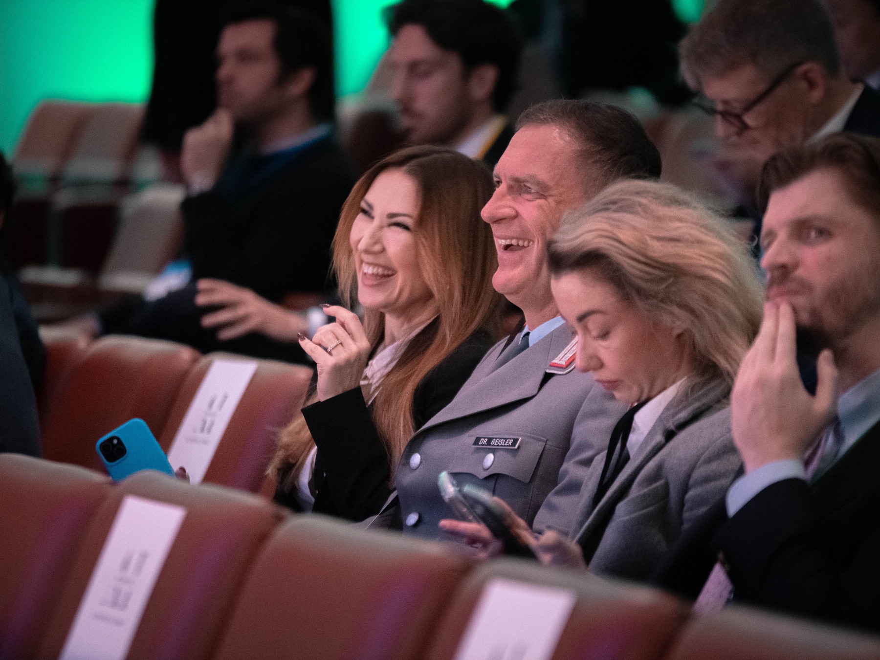 Guests reacting warmly during a TechEmbassy conference-side event.